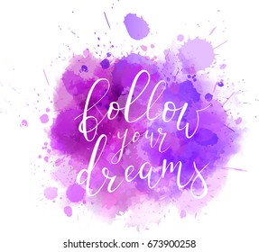 Multicolored splash watercolor blot with handwritten calligraphy text "Follow your dreams"