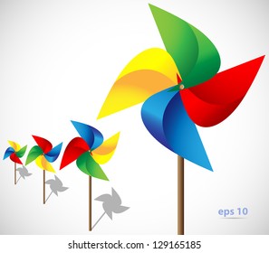 Multicolored toy paper windmill propeller. Pinwheel with blades of different colors