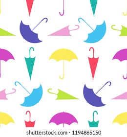 Multi-colored umbrellas in different positions. Seamless vector.