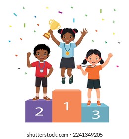 Multicultural children with medals holding gold cup trophy standing on winners podium or pedestal with first, second and third place prize celebrating winning competition