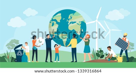 Multiethnic group of people cooperating for environmental protection and sustainability in a park: they are supporting earth together, recycling waste, growing plants and choosing renewable resources