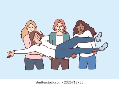 Multiethnic women students raise classmate in arms to congratulate on educational achievements and take memorable photo. Cheerful multiethnic girls get pleasure from lack of disagreement.