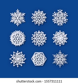 Multilayered Paper Snowflakes Set. Symmetric Papercut snow flake silhouette isolated on blue. Winter season weather decoration icon. Christmas holiday, Noel greeting card. Vector Origami art snowflake