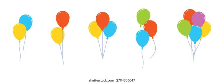 Multiple groups of colorful floating air balloons tied with strings isolated against plain white studio backdrop surface.