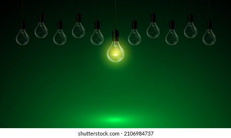 multiple light bulbs the center light on a green background.