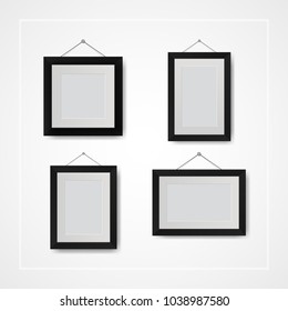 Multiple many small picture and photo frames on white wall