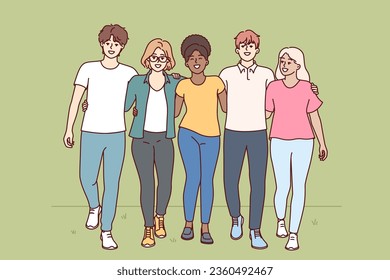 Multiracial people walk through park hugging and enjoying friendship with college classmates. Multiracial students walk together on grass and invite to become member of friendly university community