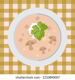 Mushroom soup in a plate on the table with a tablecloth