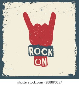 music hand drawn typography poster with sign of the horns. rock on. artwork for wear. vector illustration on grunge background