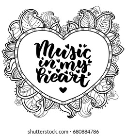 Music in my heart. Beautiful quote written by hand with a brush. The openwork heart in doodle style. Festive inscription for card, invitation or poster. Lettering for Valentine's Day or wedding.