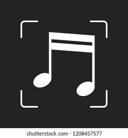 Music note icon. White object in camera autofocus on dark background