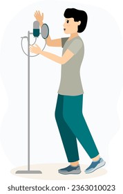 Musical concert. Boy in a gray t-shirt and with a microphone sings in a karaoke club or recording studio.