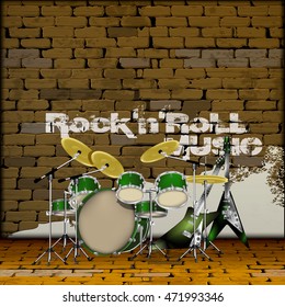 musical drum set and electric guitar on a background of an old brick wall with the inscription rock`n`roll music.