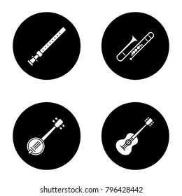 Musical instruments glyph icons set. Duduk, guitar, banjo, trombone. Vector white silhouettes illustrations in black circles