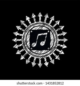 musical note icon inside chalk emblem written on a blackboard