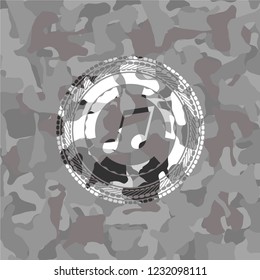 musical note icon inside grey camouflaged emblem