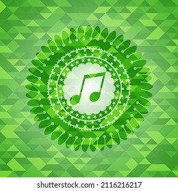 musical note icon inside realistic green mosaic emblem. 