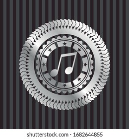 musical note icon inside silvery emblem