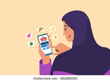 Muslim Or Arab Young Woman Buy Groceries In Online Shop B2B Web Page With A Smartphone Apps. Mobile Phone E-Commerce And Business Flat Vector Cartoon Design. Girl In Hijab Paying Vegetable And Fruit