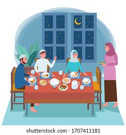 

Muslim families consisting of two parents and their children are eating their pre-dawned meal at the dinner table for fasting tomorrow. 