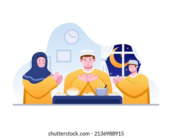 Muslim family praying before having iftar. Islamic people praying before Suhoor or Pre dawn meal. Getting ready to eat suhoor food. Can be used for Web, Social media, apps, book, print, etc.