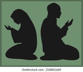 Muslim male and female silhouettes praying