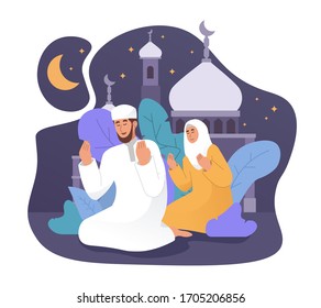 Muslim man and his wife praying together at night