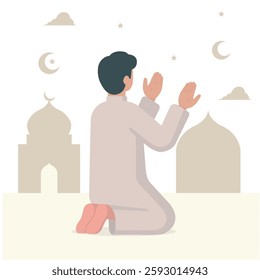Muslim man praying at night with a mosque silhouette in the background