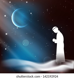 Muslim man in traditional outfits praying (reading Namaz, Islamic Prayer) on shiny moon and stars night background.
