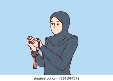 Muslim praying woman is dressed in islamic clothing with hijab and reads prayer, turning to allah for help. Praying girl believing in islam believes in arab religion and visits mosque