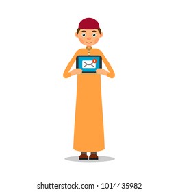 Muslim with tablet. Young muslim guy stands and holds a tablet in his hands, on which an e-mail is displayed. Illustration in flat style. Isolated. White background. 