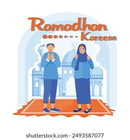 Muslim teenage boy and girl standing on carpet. Saying Ramadan greetings with a mosque in the background. Ramadan Kareem concept. Flat vector illustration.