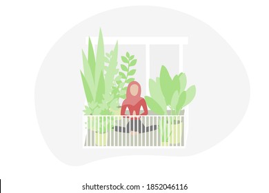 Muslim woman with hijab doing yoga on her balcony surrounded by plants. Urban jungle and relaxation, meditation in times of coronavirus pandemic social distancing