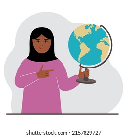 A muslim woman holds a globe in his hand and points his finger at it. The concept of education, teacher, world conquest, ecology. Vector flat illustration