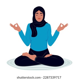 Muslim woman meditating with eyes closed and legs crossed outdoors. International Yoga Day. A woman is engaged in her favorite hobby.