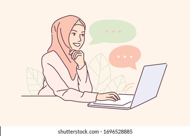 Muslim Woman sitting at laptop and using website for dating or searching for a job on internet. Girl in hijab checks email or chatting with people, or working.