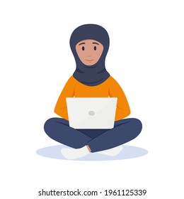 Muslim woman works at a laptop. Freelance concept.