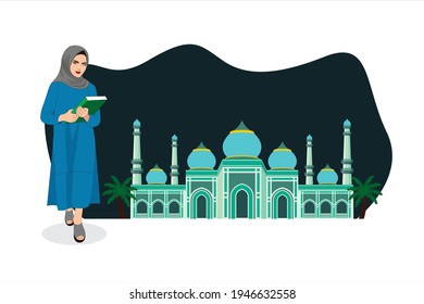 Muslim women holding Al-Qur'an bibble beside the beautiful mosque building 