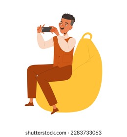 Mustached Man Character Sitting on Beanbag Chair Filming with Smartphone Working in Coworking Space Vector Illustration