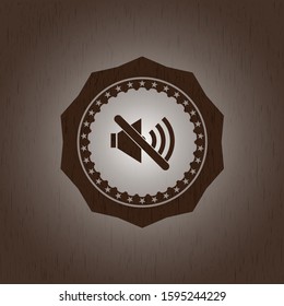 mute icon inside badge with wood background