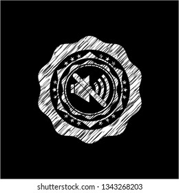 mute icon inside chalkboard emblem written on a blackboard