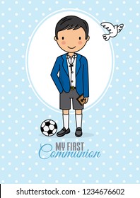 my first communion boy. Boy in communion costume and soccer ball