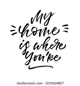 My home is where you're. Valentine's Day calligraphy phrases. Hand drawn romantic postcard. Modern romantic lettering. Isolated on white background.