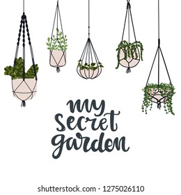 My secret garden hand written lettering and flower in flower pots hanging. Indoor garden concept