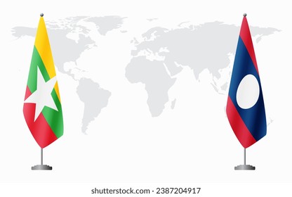  Myanmar and Laos flags for official meeting against background of world map.