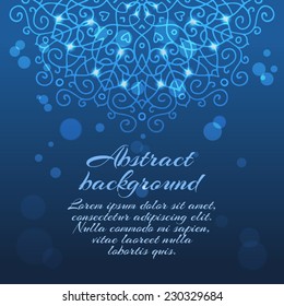 Mysterious abstract blue background with a mandala ornament, sparkles and bokeh