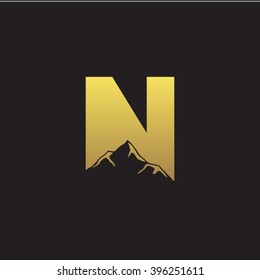 N alphabet mountain negative space letter logo gold black background