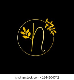 N Gold letter and Gold Leaf logo design. N Letter golden initial luxury Boutique Nature Floral Flower. N Monogram vector design concept and with leaf for fashion brand and luxuries business identity.
