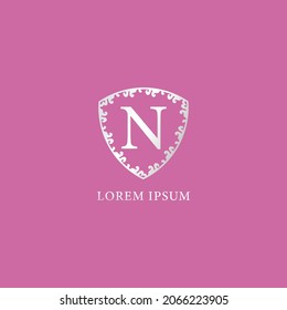 N Letter Intial logo design template. Luxury silver decorative floral shield illustration. Isolated on pink color background. Suitable for Insurance, fashion and beauty product.