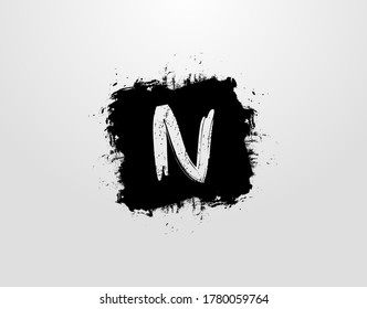 N Letter Logo With Black Square Splatter Element. Grunge Retro logo design template.